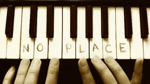 photo of a keyboard with the words No Place written on the white keys