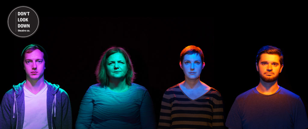Four people on a black backdrop, looking somber.