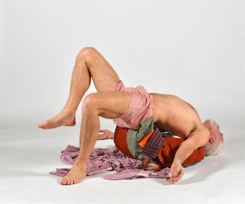 Photo of Johannes Zits lying bent backbackwards on a pile of clothes