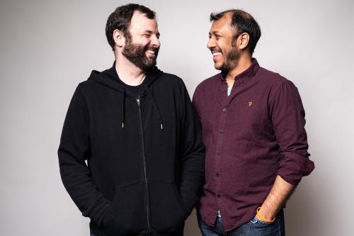 Photo of Nicolas Billon and Ravi Jain looking at each other and laughing