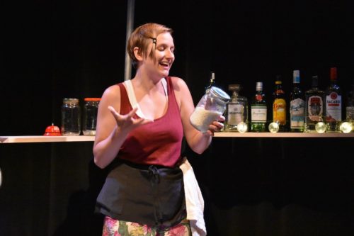 Bartender holds a jar of rice. 