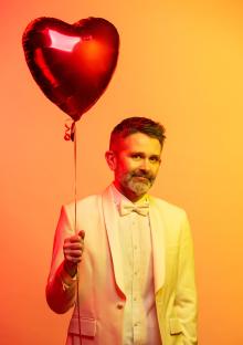 Image of Brian Francis holding a balloon in Box 4901